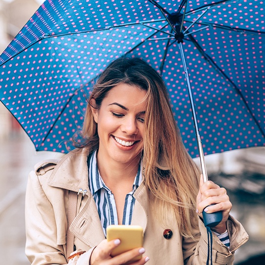 Smiling woman under an umbrella