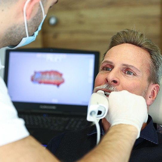 Dentist capturing digital impressions of teeth
